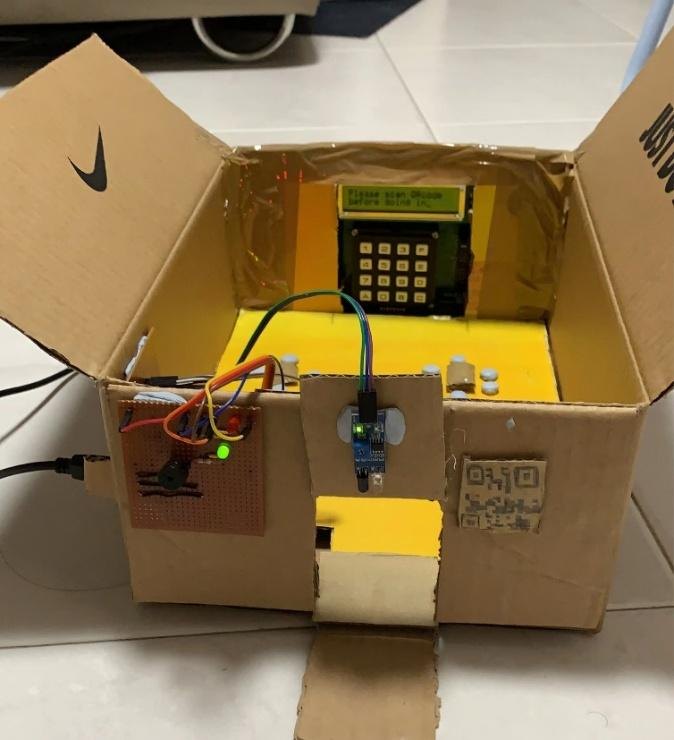 The prototype in a cardboard enclosure, with an LCD display, keypad and sensors