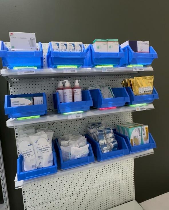 The smart shelf: blue stock bins, each with a green or red LED strip underneath